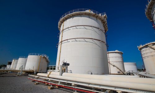 Row of large white tanks for petrol pipeline oil tank terminals